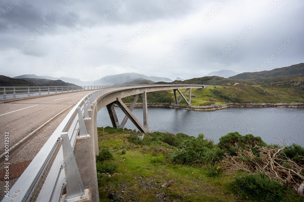Scenic view of the Kylesku Bridge arching over a river in Scotland