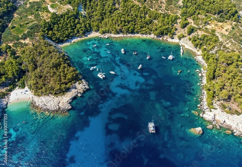 Aerial photo of boats moored at beautiful Velo Borce beach on Hvar island in Croatia