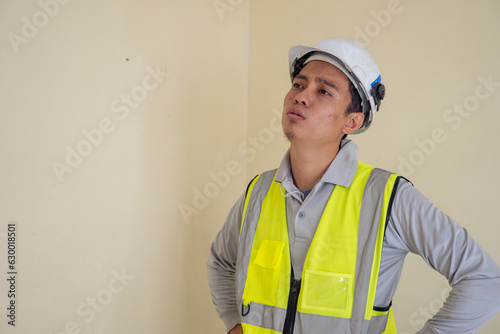 Young construction guys sigh expression. The photo is suitable to use for engineer poster and safety content media. photo