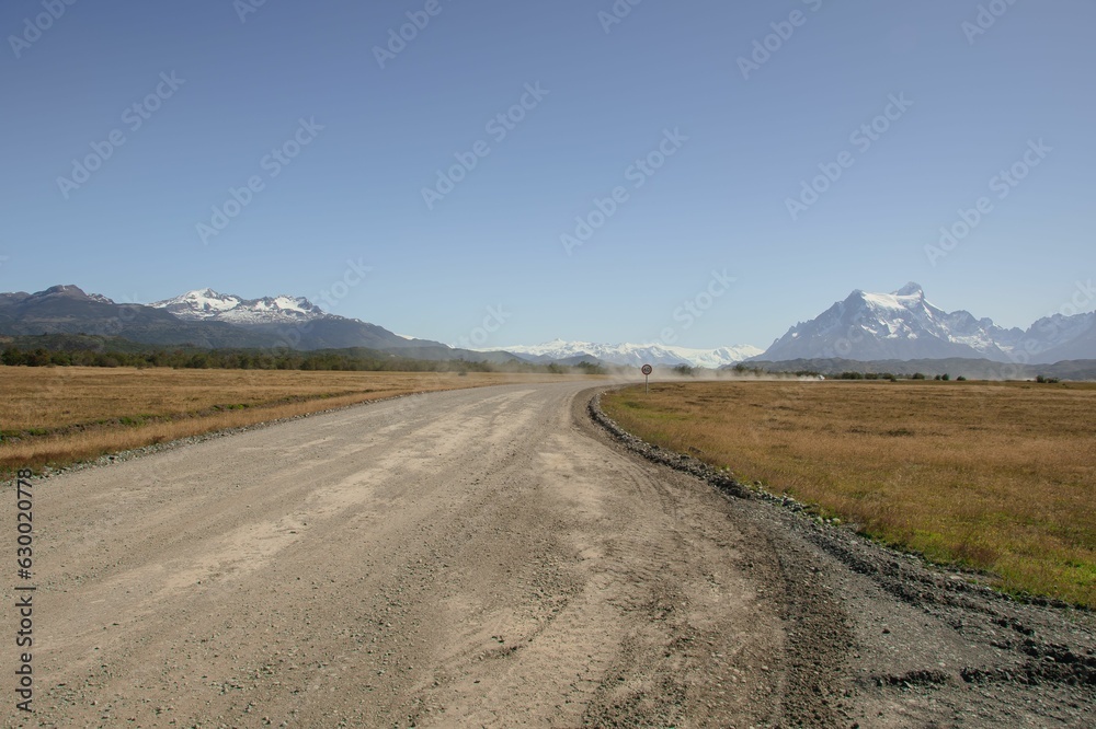 Road surrounded by mountains and grass Road surrounded by mountains and grass