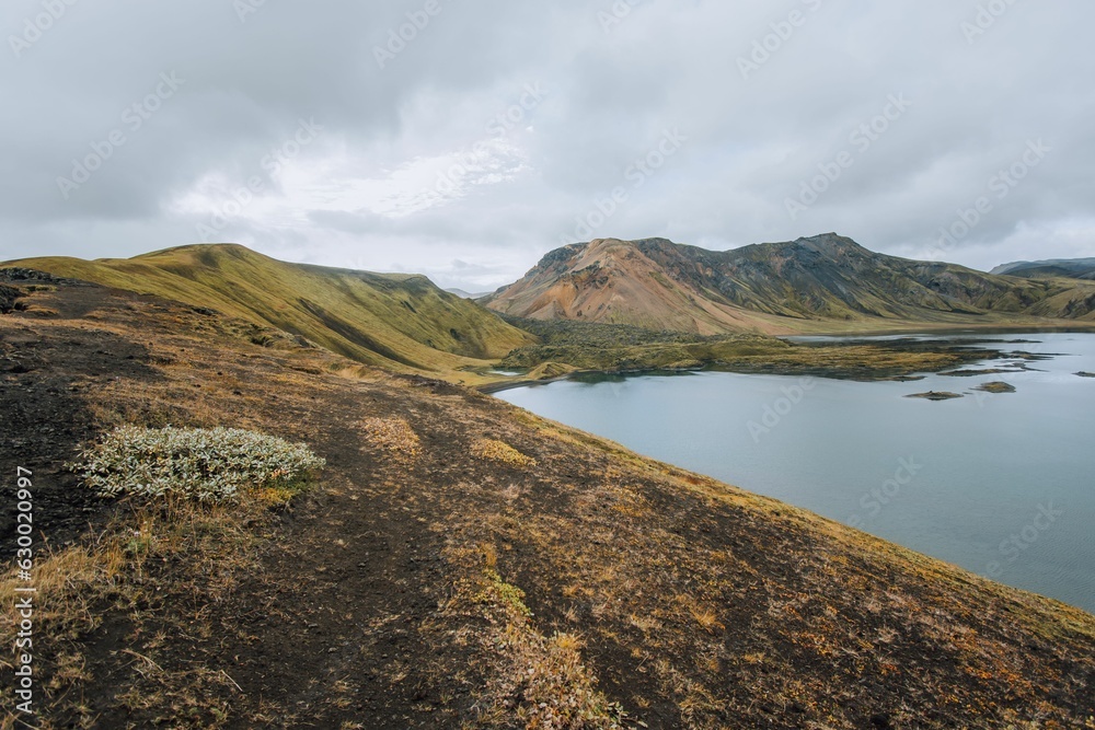 Tranquil lake surrounded by majestic mountains. Landmannalaugar, Iceland.