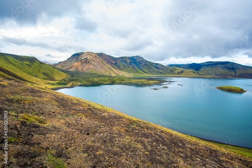 Scenic view of a tranquil lake surrounded by majestic mountains. Landmannalaugar, Iceland.