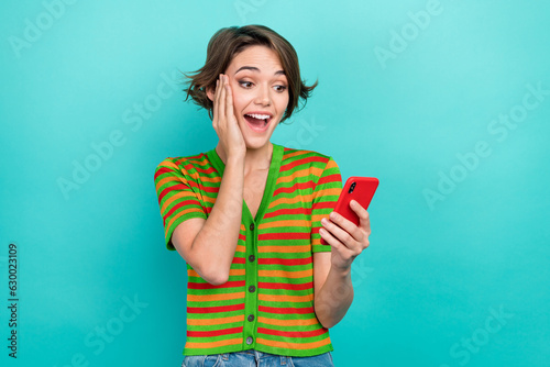 Photo of adorable impressed lady wear striped cardigan reading iphone apple samsung gadget arm cheek isolated teal color background