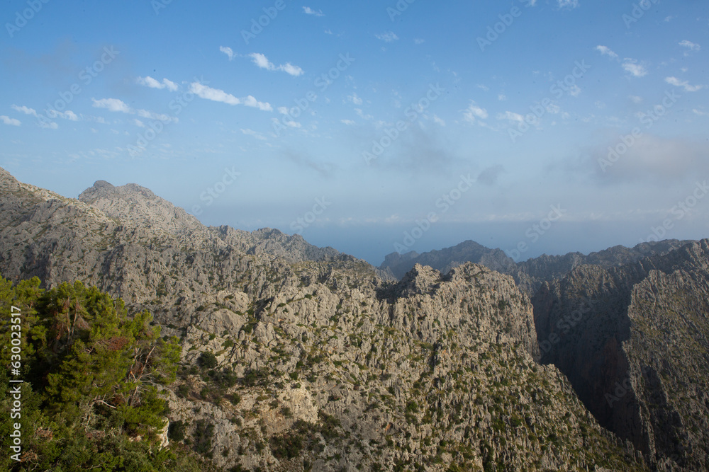 Naklejka premium Hiking holidays Mallorca, Spain. Beautiful picture with landscape of Serra de Tramuntana mountains in the island of Majorca in Mediterranean sea. Paradise for bikers. Adventure travel.