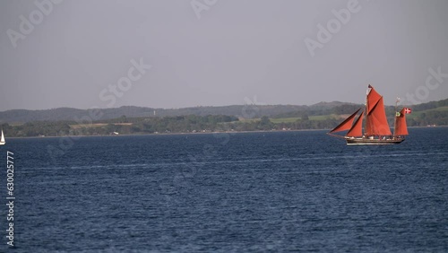 Boat Festival in Denmark Aarhus, Scandinavia, Modern sailing yacht entering old traditional scandinavian harbor, mast sailing ancient viking ship downwind close up Yachts During Summer Sailing Regatta photo