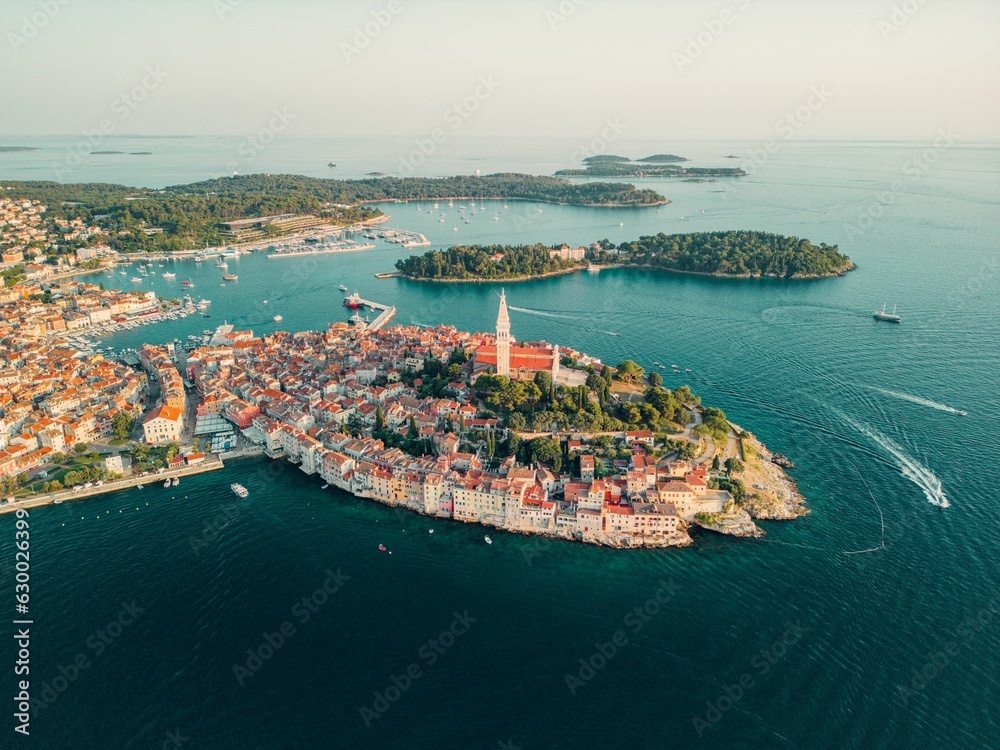 Aerial shot of a picturesque village situated on the shore of a tranquil body of water in Croatia