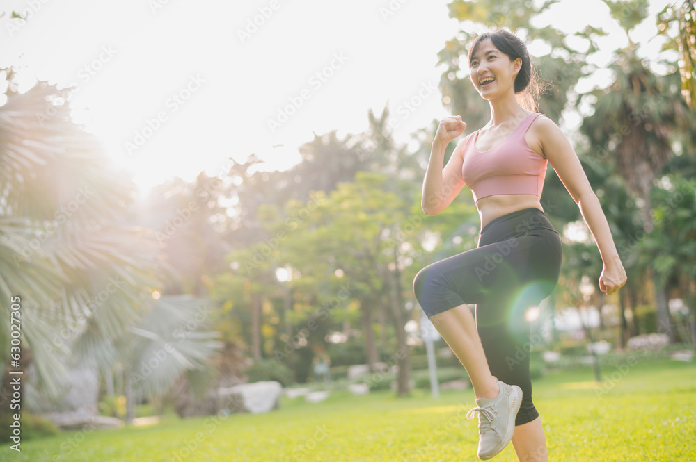 Immerse yourself in the concept of wellness and well-being as a fit Asian woman in 30s wearing pink sportswear exercising in public park at sunset. the inspiring display of healthy outdoor lifestyle.