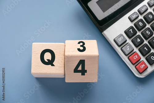 Quarterly report concept.Company financial report.Business charts. Wooden cube represent quarter third and fourth. photo
