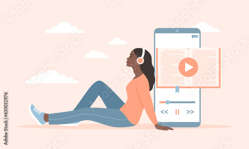 A young black woman in headphones sitting near a large smartphone with an audiobook app on the screen. A woman listening to an audio book. Flat vector illustration