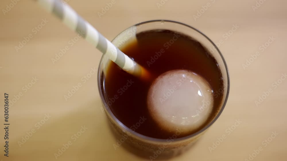 Glass of cold brew coffee with ice and straw Glass of cold brew coffee with ice and straw