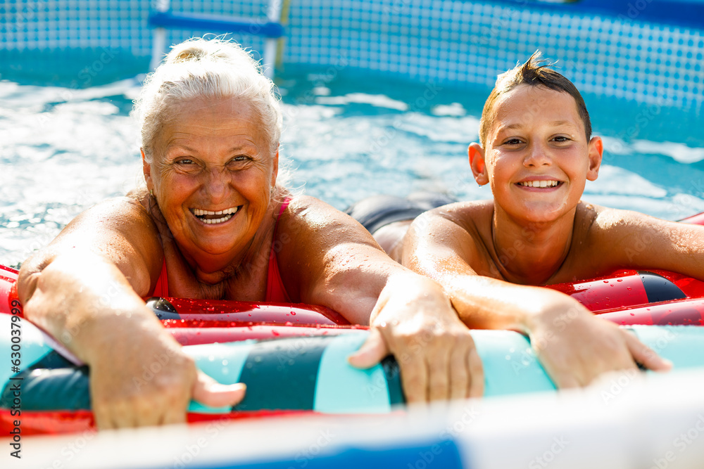 Fototapeta premium A family having fun in the swimming pool