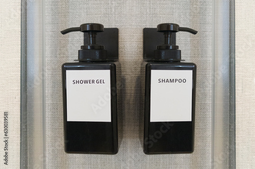 Obraz na płótnie Liquid gel and shampoo dispensers attached to shower wall w salonie