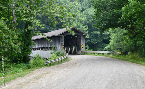 Vintage and historic wooden covered bridge on empty road