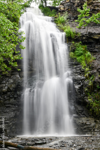 Natural waterfall along the hiking path in the forest woods © BradleyWarren