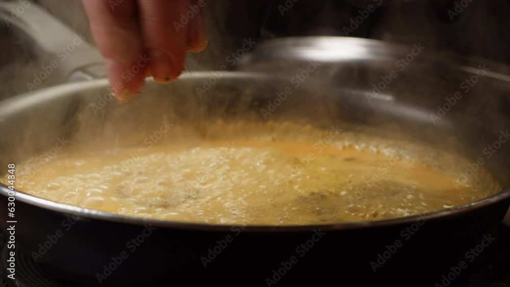 Boiling cooking creamy white sauce for pasta or pizza in pan, close-up sauce boiling in a pan. Healthy boiled vegetables for cream vegan soup. Boiling cooking creamy white sauce for pasta or pizza in pan, close-up sauce boiling in a pan. Healthy boiled vegetables for cream vegan soup.