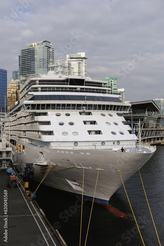 View onto ultra luxury all inclusive white Regent cruiseship cruise ship liner Explorer in port of Vancouver, Canada at terminal for Alaska cruising during twilight early morning  © Tamme