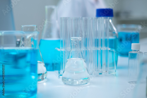 Glassware, beaker or test tube with blue substance or liquid. Concept of laboratory background. Scientific analysis tools background. Chemistry and experiment glassware.