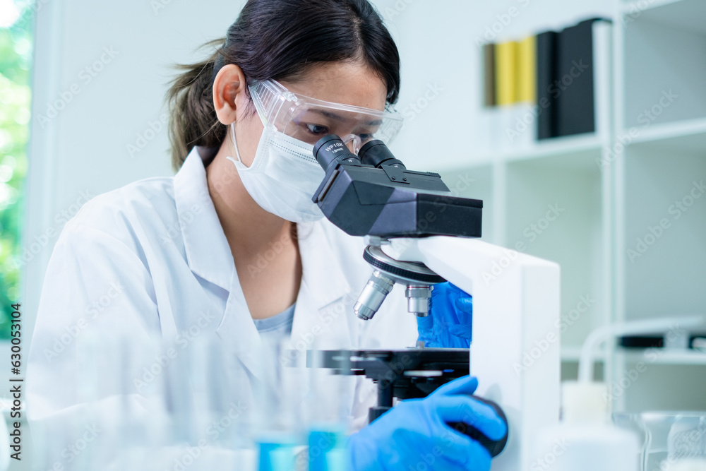 Medical Research Laboratory. Female Scientist Using Microscope to analyze substance or liquid, virus. Professionals Working in Advanced Scientific Lab doing Medicine, Vaccine, Biotechnology test Medical Research Laboratory. Female Scientist Using Microscope to analyze substance or liquid, virus. Professionals Working in Advanced Scientific Lab doing Medicine, Vaccine, Biotechnology test