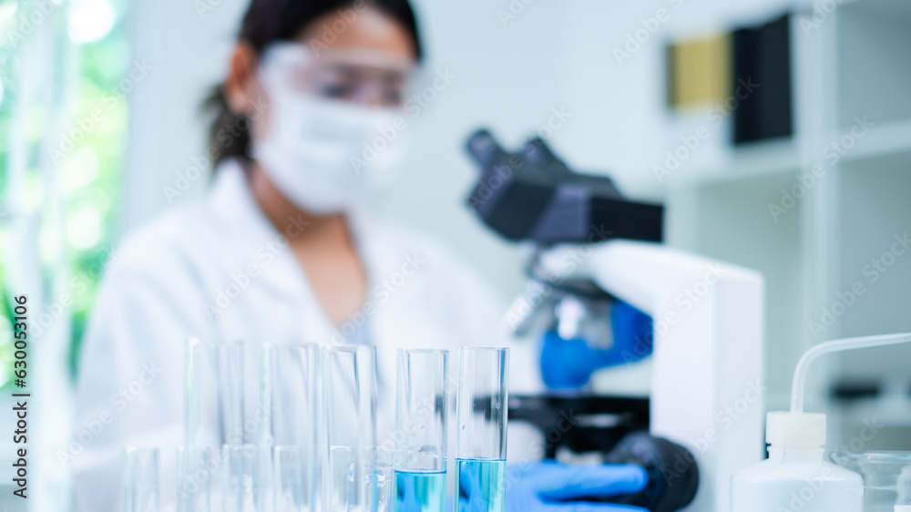Medical Research Laboratory. Female Scientist Using Microscope to analyze substance or liquid, virus. Professionals Working in Advanced Scientific Lab doing Medicine, Vaccine, Biotechnology test Medical Research Laboratory. Female Scientist Using Microscope to analyze substance or liquid, virus. Professionals Working in Advanced Scientific Lab doing Medicine, Vaccine, Biotechnology test