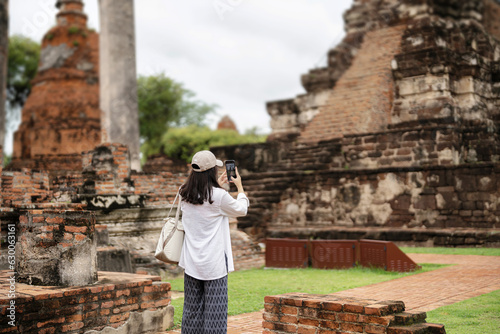 Asian women walking tour of ancient sites in Ayutthaya, Thailand, Historical park..