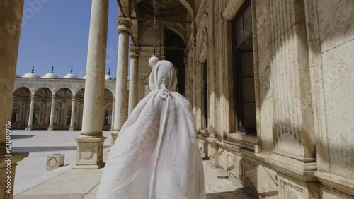 Woman is walking towards the Great Mosque of Muhammad Ali Pasha.