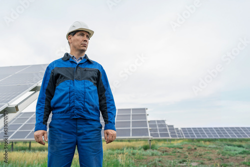 Service Engineer man standing in front of solar panels. Technician maintenance solar cells on Solar Energy Plant under morning sunlight. Technology solar energy renewable © Николай Амосеев