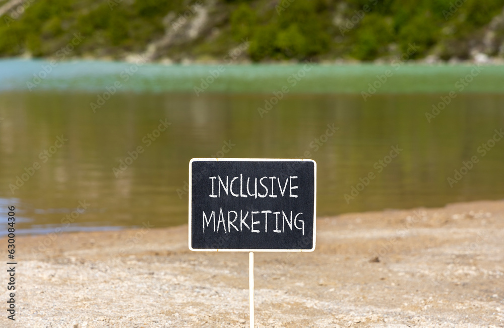 Inclusive marketing symbol. Concept words Inclusive marketing on beautiful black blackboard. Beautiful mountain lake background. Business inclusive marketing concept. Copy space.