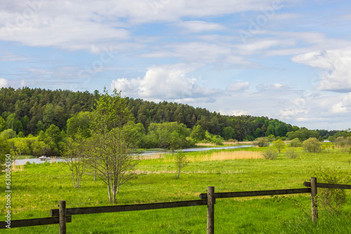Beautiful peaceful countryside landscape view on pale blue sky background. Sweden.