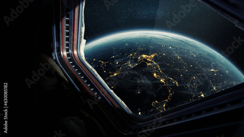 Fototapeta Naklejka Na Ścianę i Meble -  Spaceship flies near the amazing night planet earth, view from the window. Travel and tourists in space, concept. Beautiful space view of the Earth with night city lights. Hotel in space