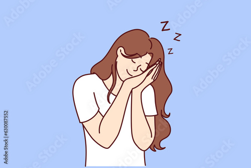 Woman sleeping standing and smiling resting head in hands, needing rest due to overwork. Happy girl sleeping and having pleasant dreams not wanting to wake up, for siesta or midday nap concept