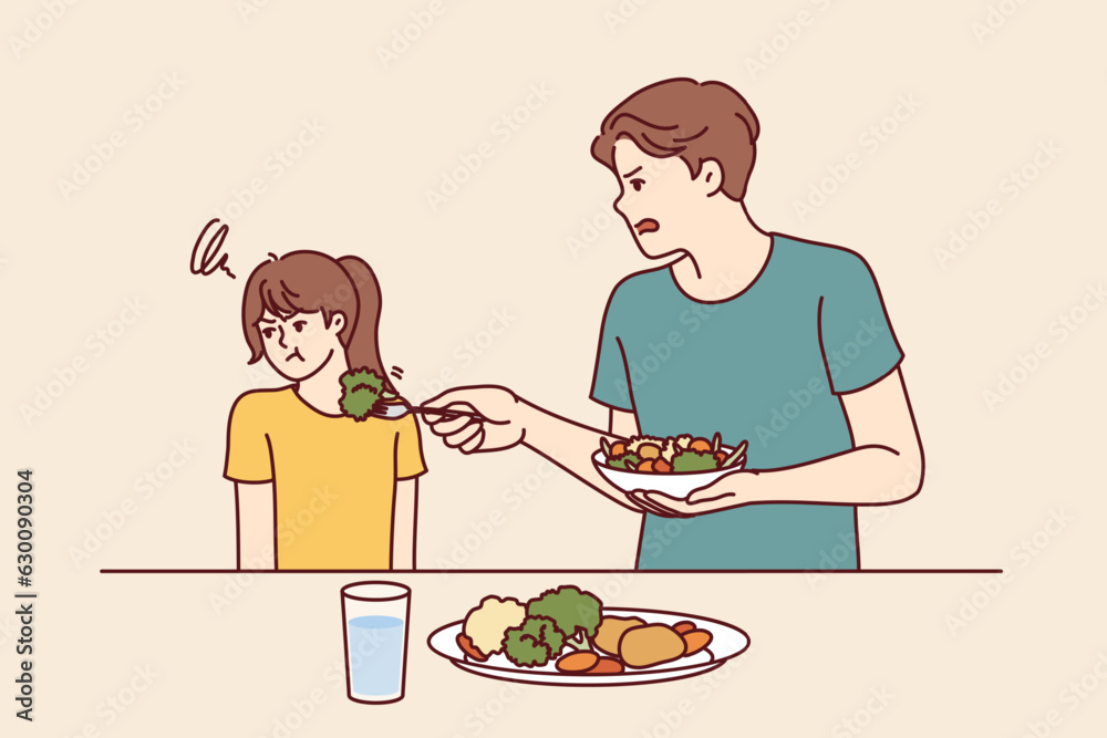 Child does not want to eat salad and green vegetables standing near father trying to teach daughter eat healthy food. Stubborn teenage girl refuses healthy vegetables and turns away. Child does not want to eat salad and green vegetables standing near father trying to teach daughter eat healthy food. Stubborn teenage girl refuses healthy vegetables and turns away.