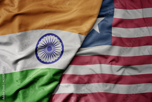 big waving realistic national colorful flag of india and national flag of liberia .