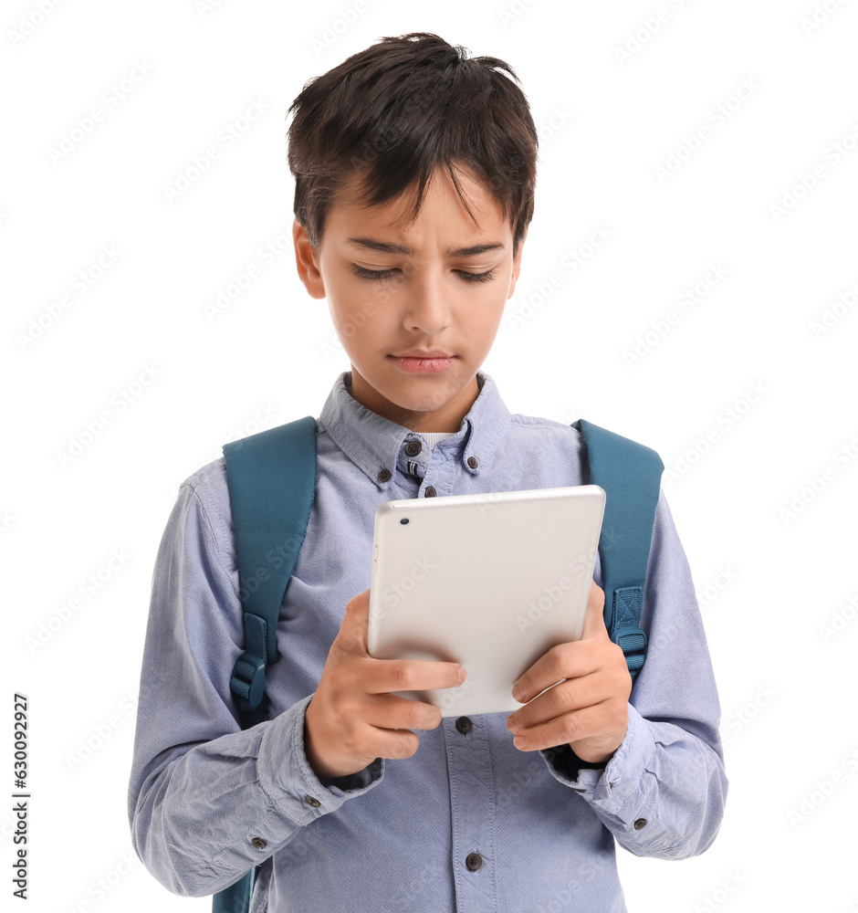 Sad little schoolboy using tablet computer on white background Sad little schoolboy using tablet computer on white background