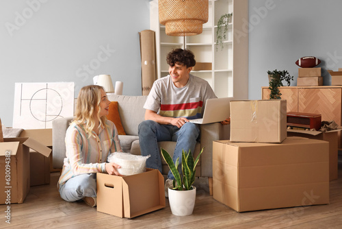 Young couple using laptop i...