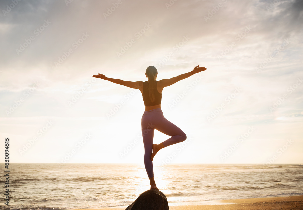 Fototapeta premium Young slim caucasian lady in sportswear practice yoga on stone, enjoy breathing exercises, balance and freedom