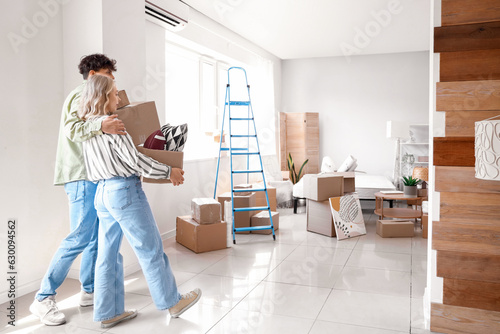 Young couple moving into ne...