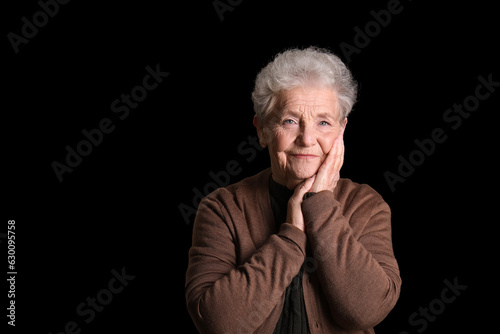 Senior woman on black background © Pixel-Shot