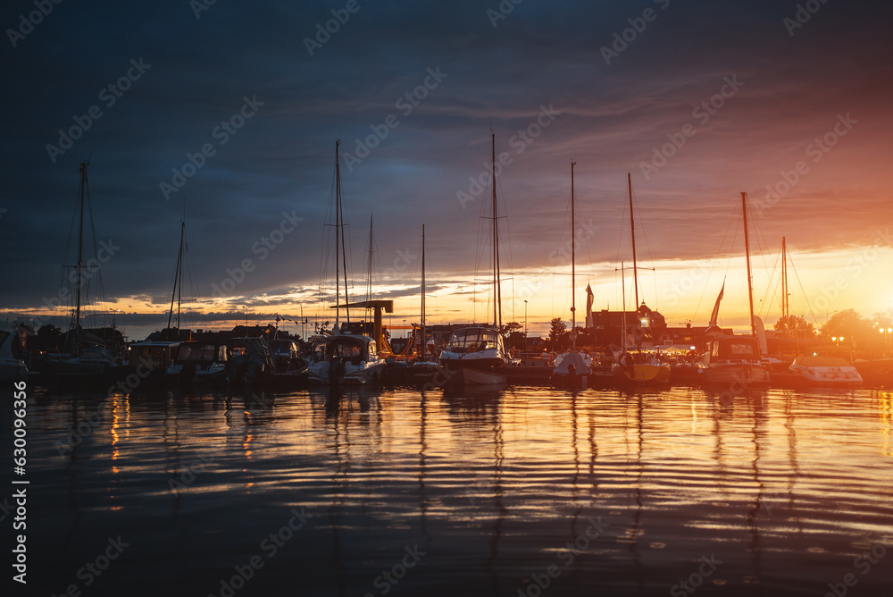 port with luxury yachts and ships and sunny blue sky at sunset or sunrise