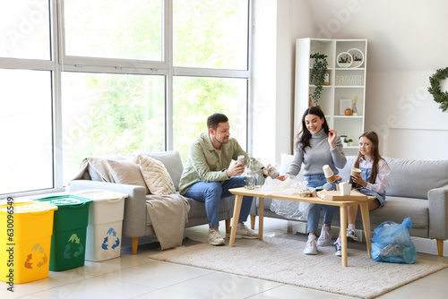 Family sorting garbage at home