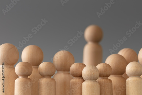 Business and entrepreneurship concept. Audience at the conference together. Wooden figures on grey background.