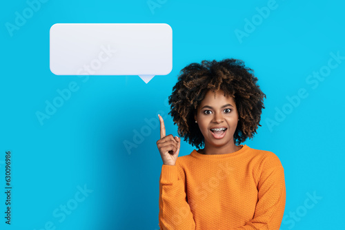 Excited black lady raising finger up, showing blank speech balloon