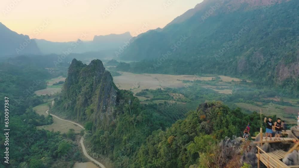 Aerial view of Nam Xay view point in Vang Vieng, Laos. Cinematic drone shot of famous tourist travel destination at sunset
