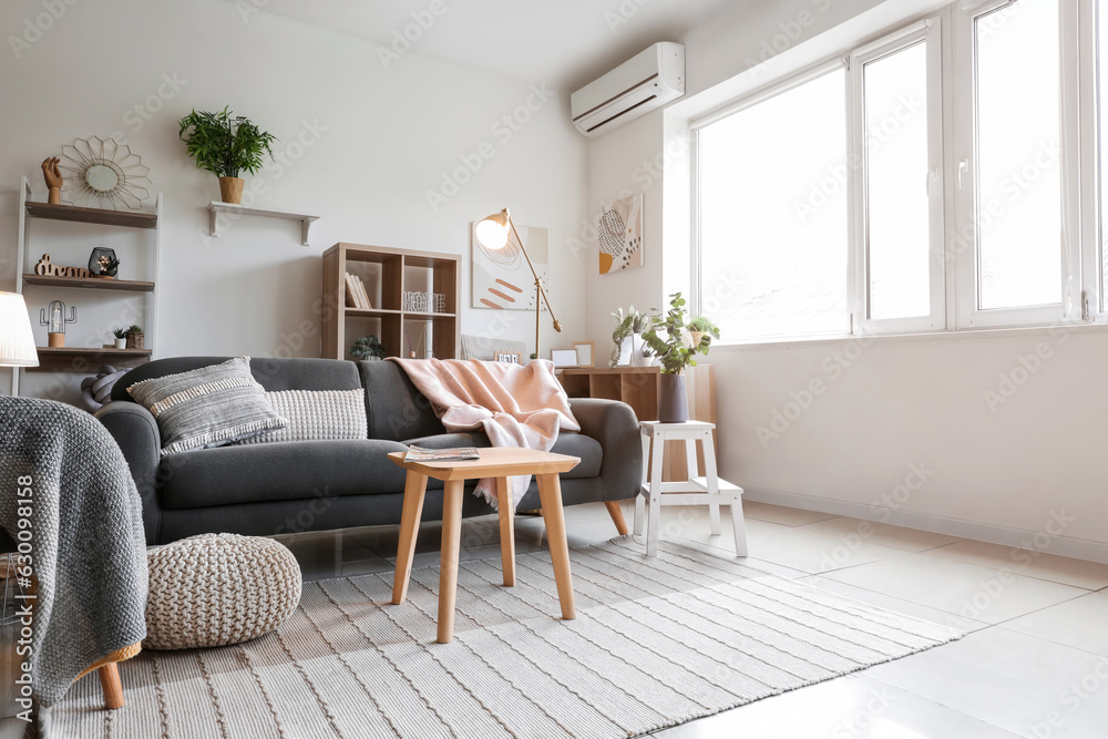 Fototapeta premium Interior of light living room with glowing lamps and sofa