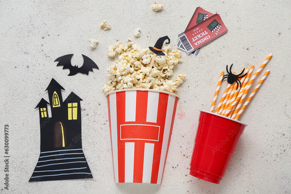 Composition with tasty popcorn, straws and cinema tickets on light