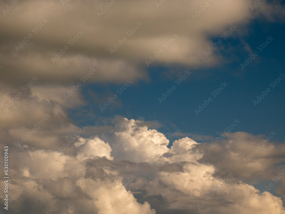 Single fluffy cloud over sunset sky background. Fluffy cumulus cloud shape photo