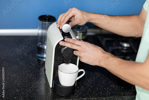 Man making coffee in coffee machine at home