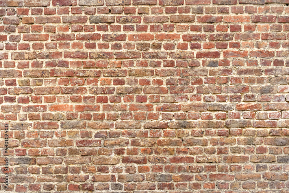 Naklejka premium Old red brick wall with different shades. Texture of a brick wall