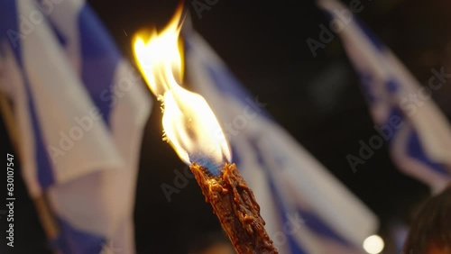 Protesters in Israel march with tourches during protest against judicial reform photo