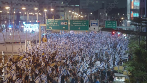 Thousands of people wave Israeli flags during demonstrations photo