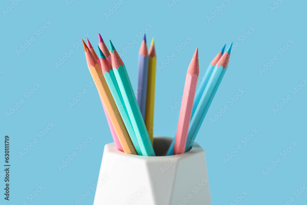 Fototapeta premium Holder with different pencils on color background, closeup